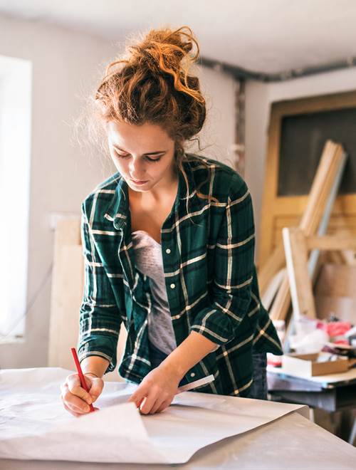 Woman working at table, drawing, creative studio at home..jpg