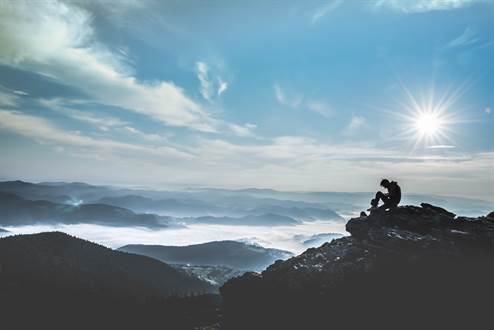 Man sitting on a mountains peak